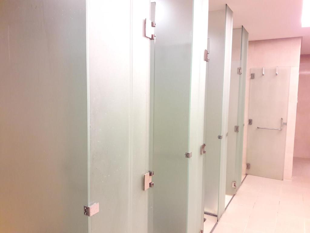 a row of white doors in a dressing room at Bluesky Serviced Apartment Airport Plaza in Ho Chi Minh City