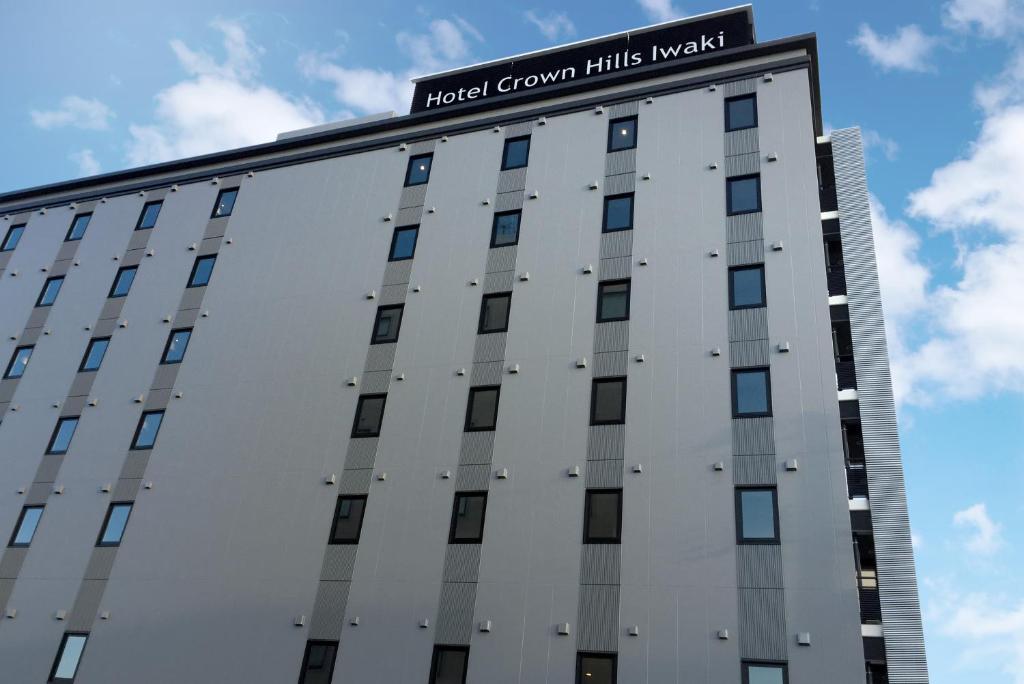 a building with a sign on the top of it at Hotel Crown Hills Iwaki in Iwaki