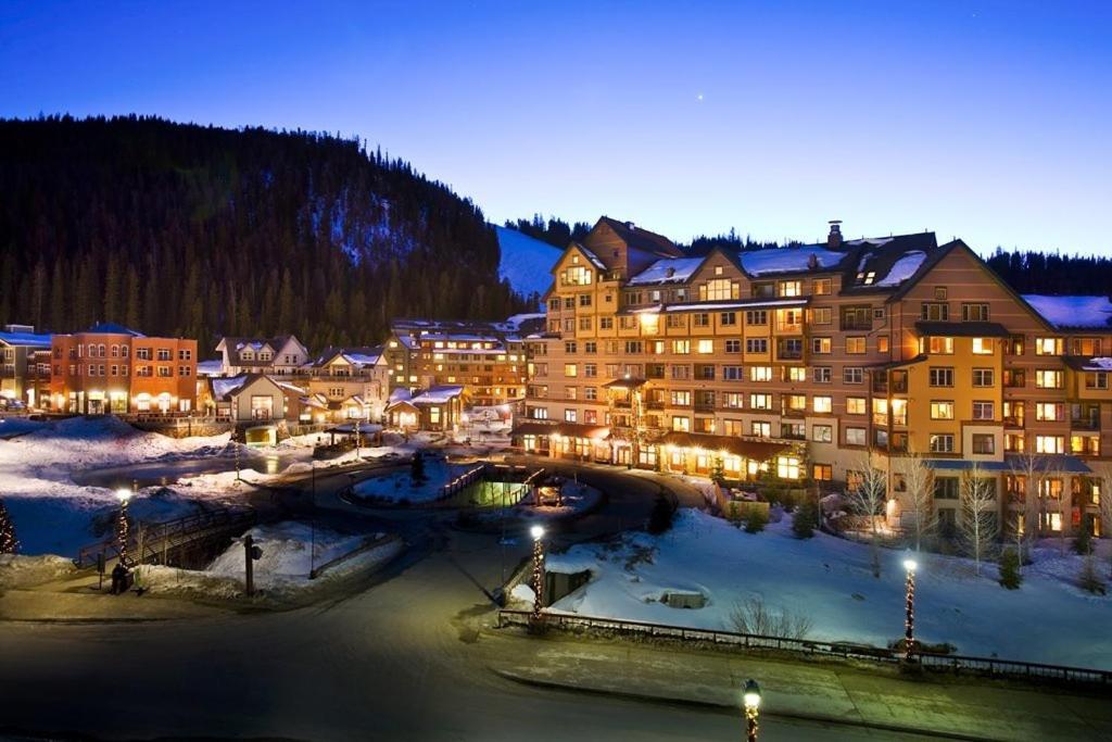 a hotel in a town with a river at night at Zephyr Mountain Lodge in Winter Park
