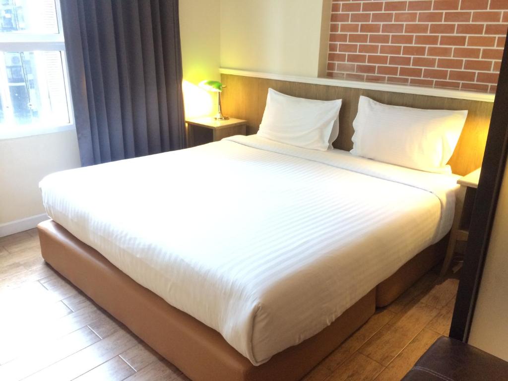 Postel nebo postele na pokoji v ubytování Bourbon St. Boutique Hotel