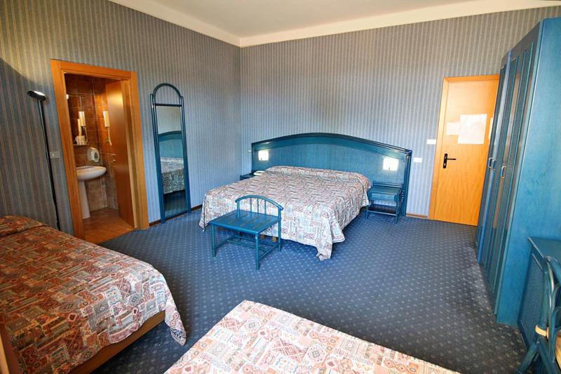 Postel nebo postele na pokoji v ubytování Hotel Kristina