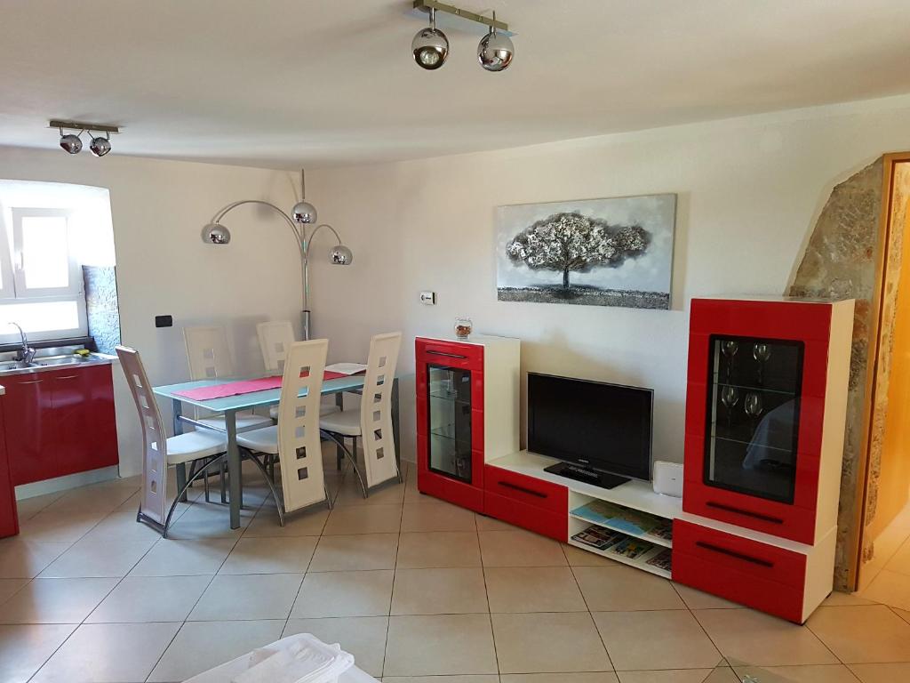 a living room with a table and a television at Apartment Chuck in Krk