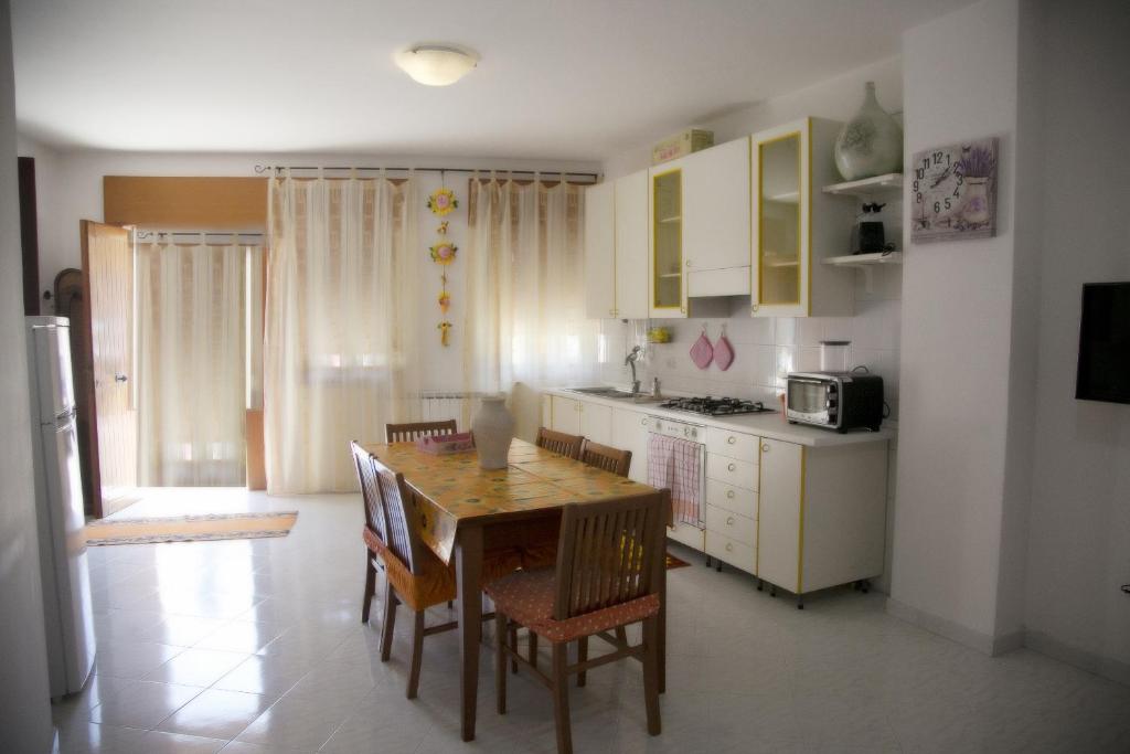 a kitchen with a table and chairs in a room at Casa Vacanza "Romano" in Pimonte