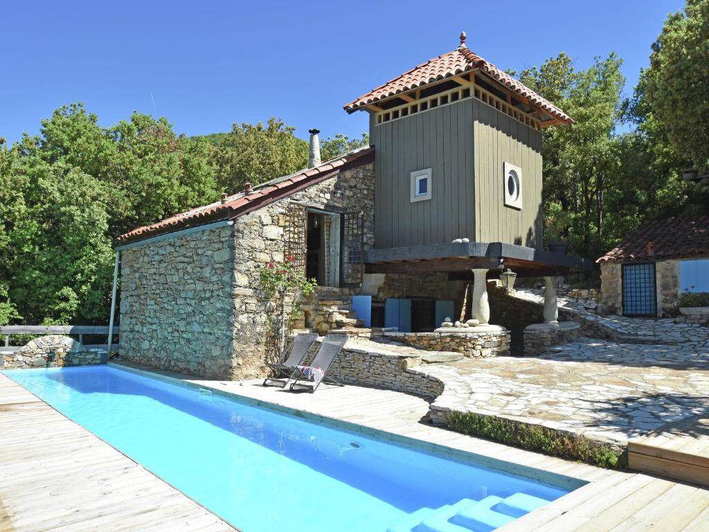 a house with a swimming pool next to a building at Charming villa with private pool in Prémian