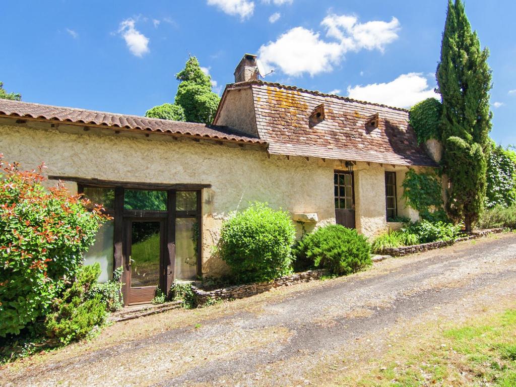 een oud stenen huis aan een weg bij Cosy Holiday Home in Bourgnac with Private Pool in Bourgnac