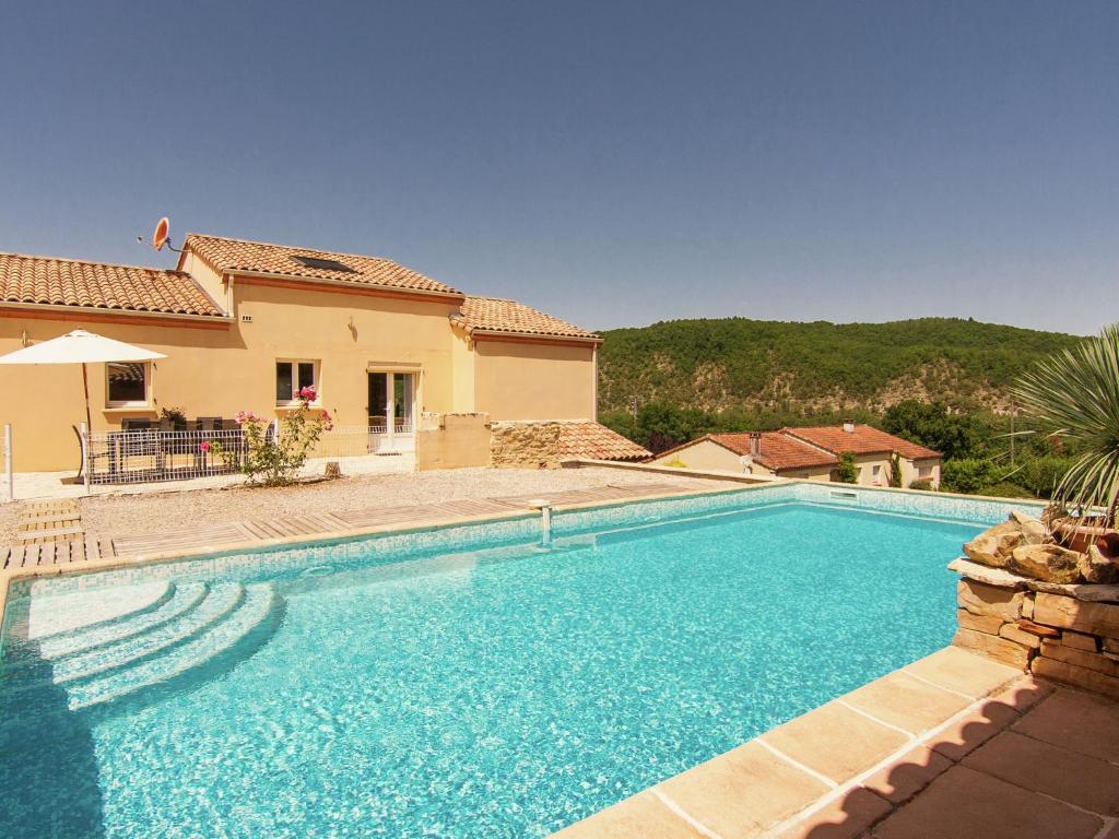 a swimming pool in front of a house at Peaceful Villa in Calamane with Private Pool in Calamane