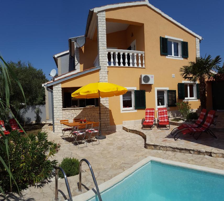 a villa with a swimming pool and a house at Casa Susanna in Kaštelir