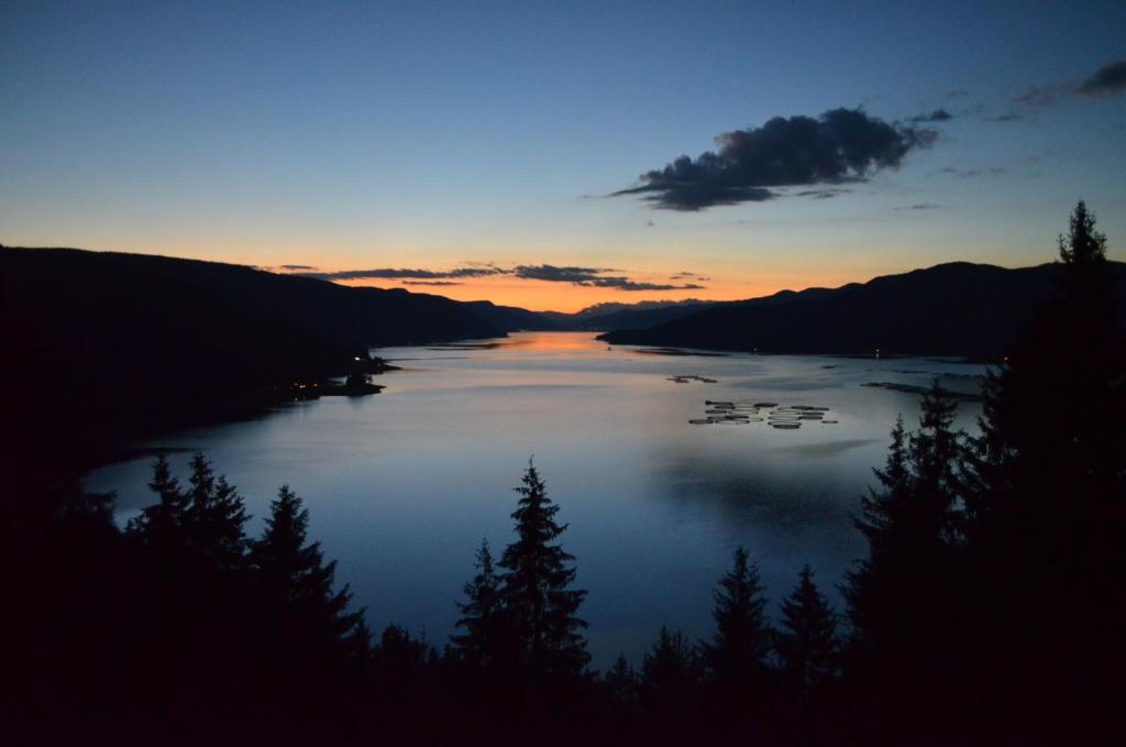 a view of a lake at sunset with trees at EldoSport Hotel in Dospat