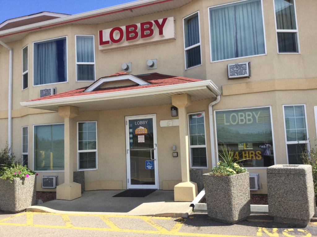 a hotel with a lobbey sign on the front of it at Western Budget Motel East Red Deer in Red Deer