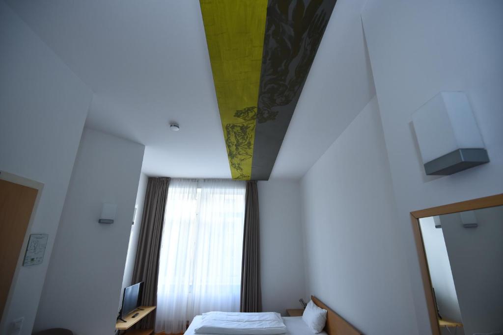 Postel nebo postele na pokoji v ubytování Art-Hotel Robert Mayer