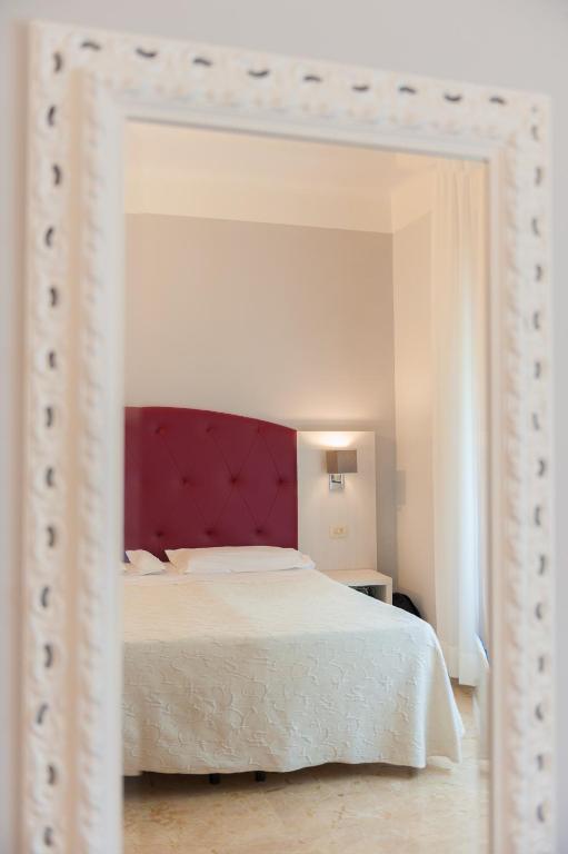 A bed or beds in a room at Albergo Battelli