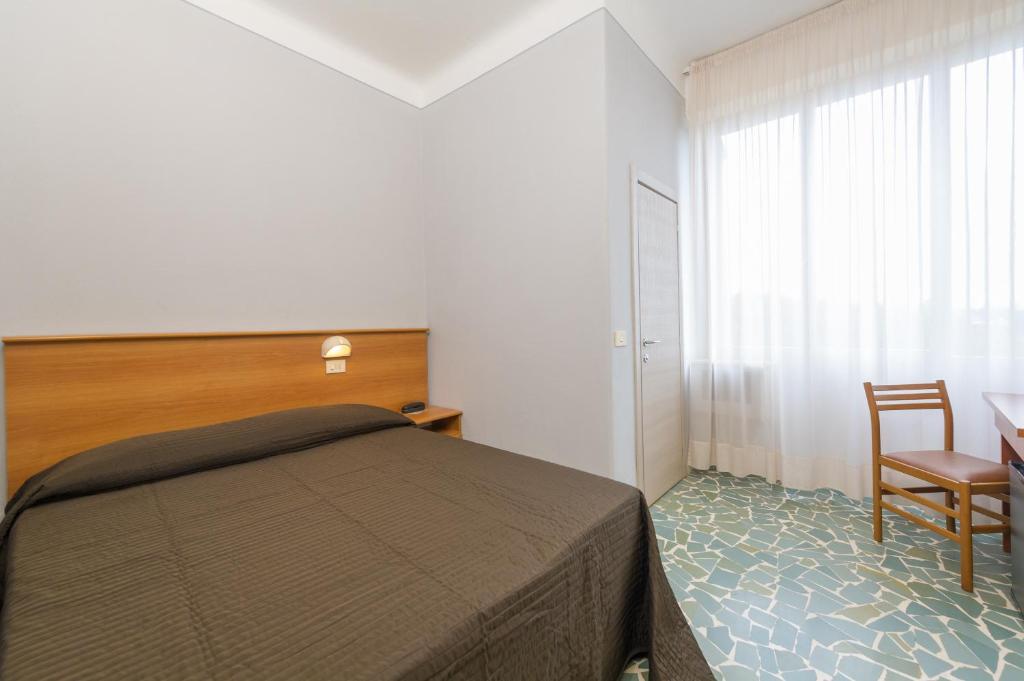 A bed or beds in a room at Albergo Battelli
