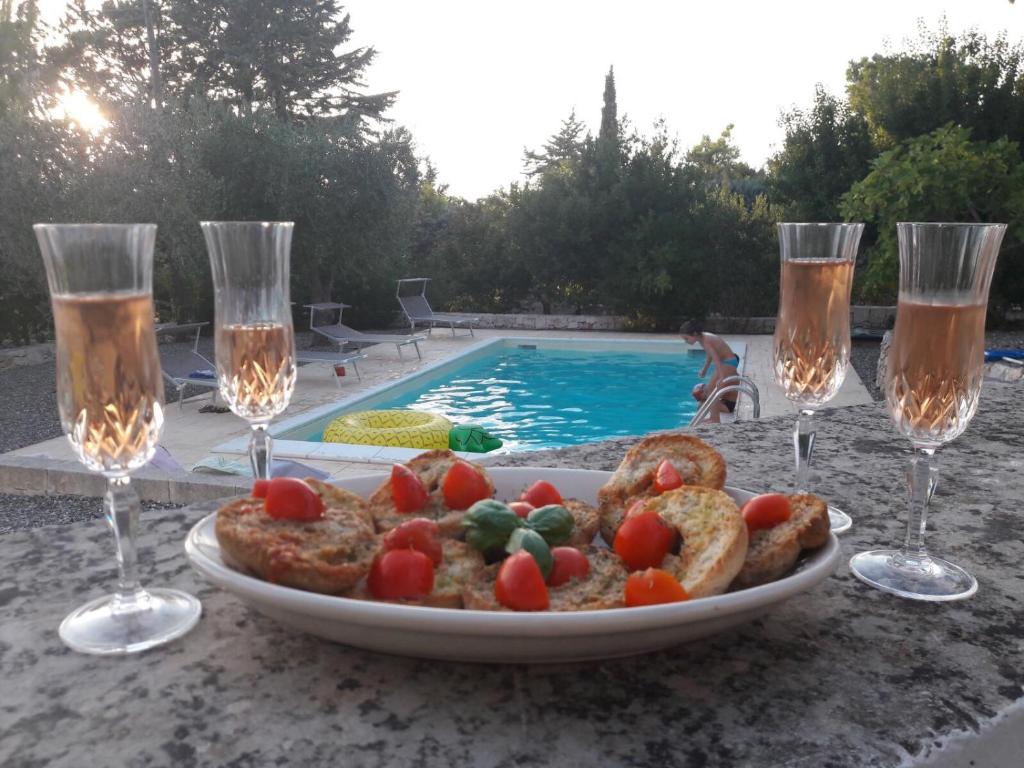 a plate of food on a table next to a swimming pool at iTrulliescape in Locorotondo