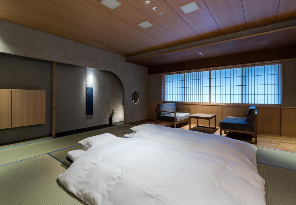 Postel nebo postele na pokoji v ubytování Kinosaki Onsen Nishimuraya Hotel Shogetsutei