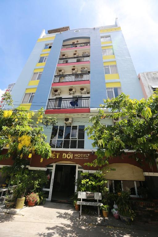 Un edificio alto con un cartello che legge la prima casa in pentola di Nhiet Doi Hotel a Tuy Hoa