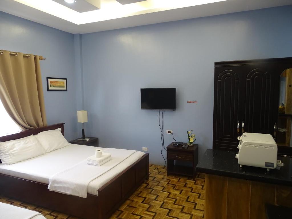 Postel nebo postele na pokoji v ubytování Ralphseej Pension House