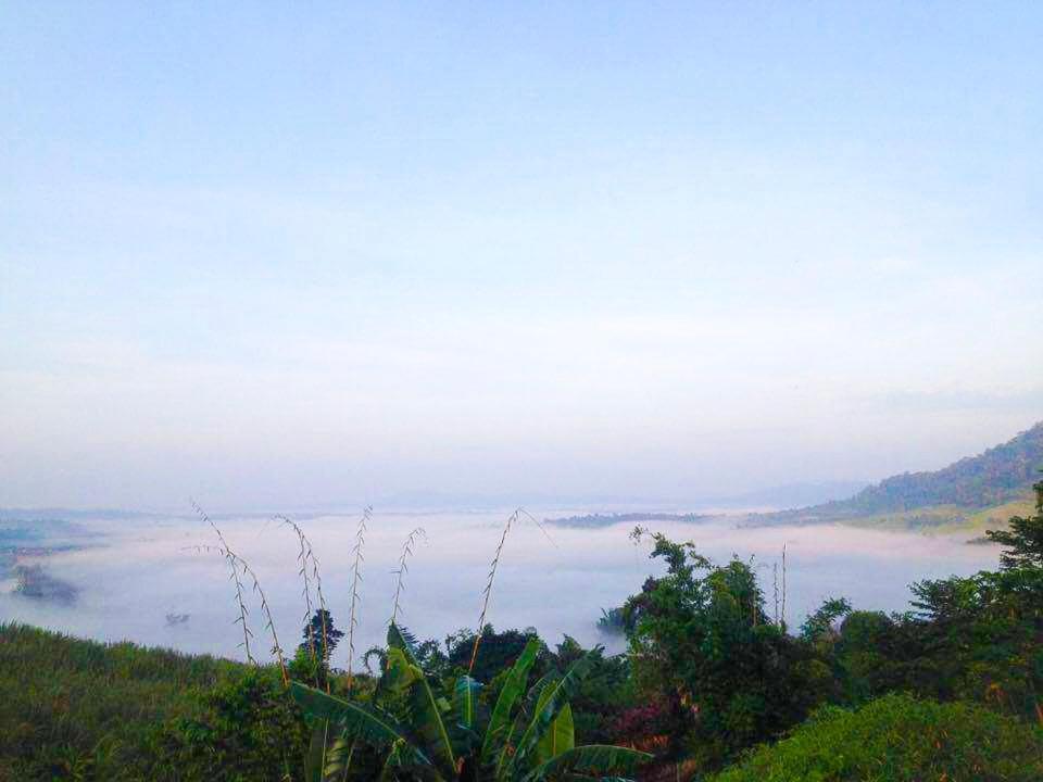 a view from the top of a hill with fog in the valley at Thanorm Rak Resort in Khao Kho