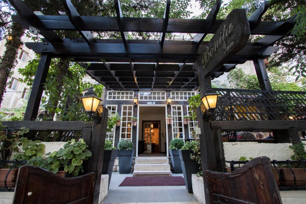 an entrance to a building with a wooden pergola at Bonita Inn in Amman