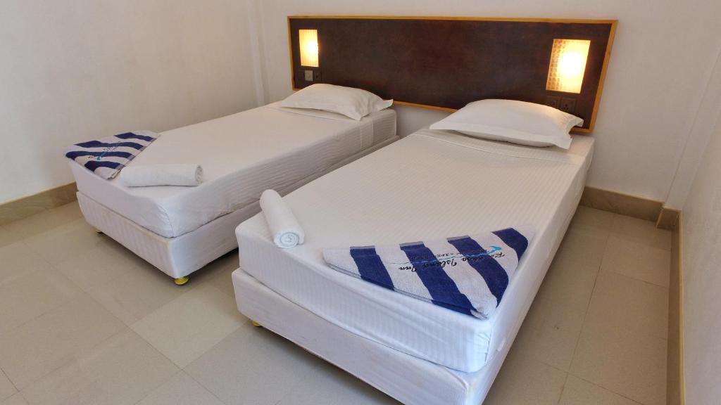 Postel nebo postele na pokoji v ubytování Rasdhoo Island Inn Beachfront