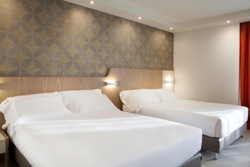 Postel nebo postele na pokoji v ubytování Hotel Aria
