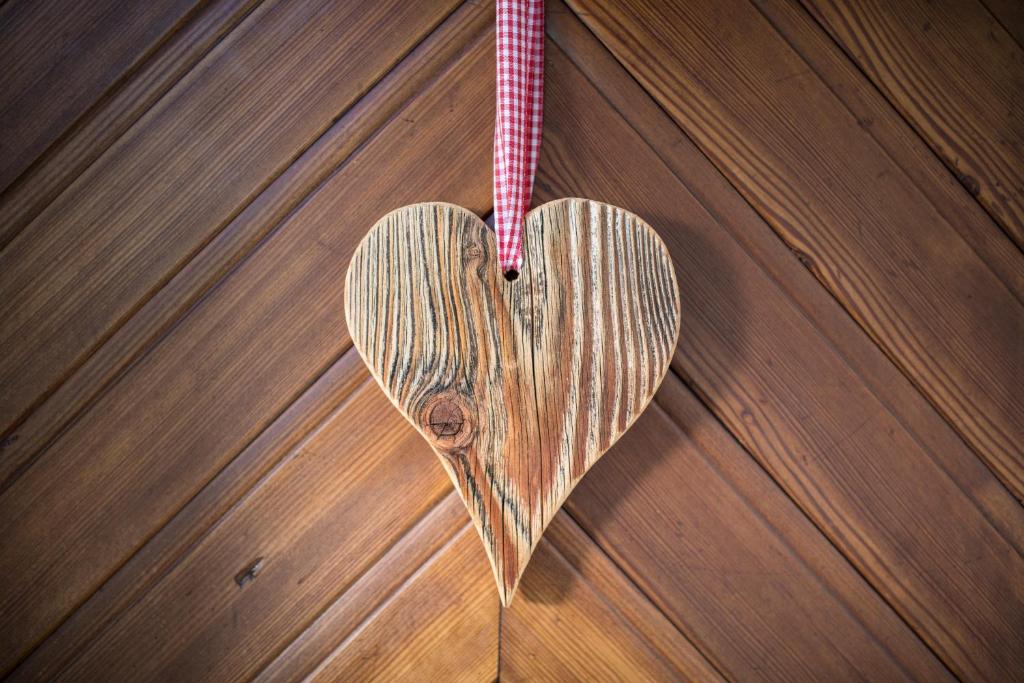 a wooden heart hanging on a wooden table at Pension Winklerkreuz in Alpbach