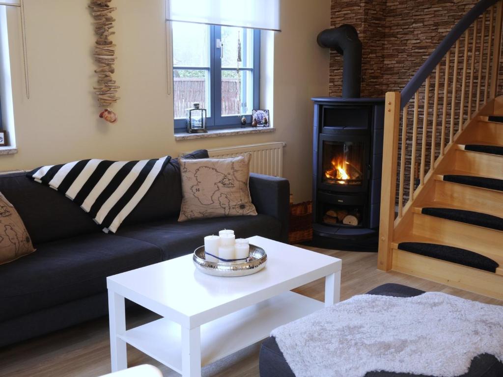 a living room with a couch and a fireplace at Ferienhaus Hendrikje in Kamminke