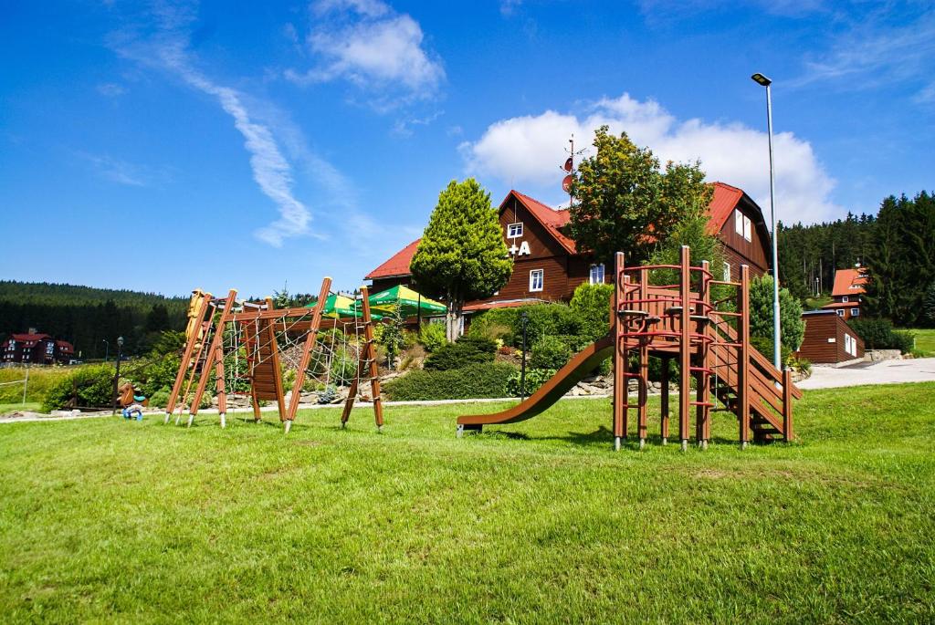 a park with a playground with a slide at Penzion A+A in Pec pod Sněžkou