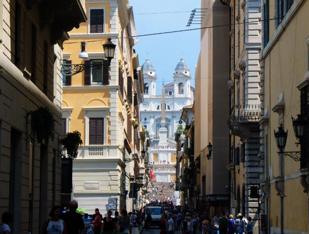 a group of people walking down a street with buildings at Nobildonne Relais in Rome