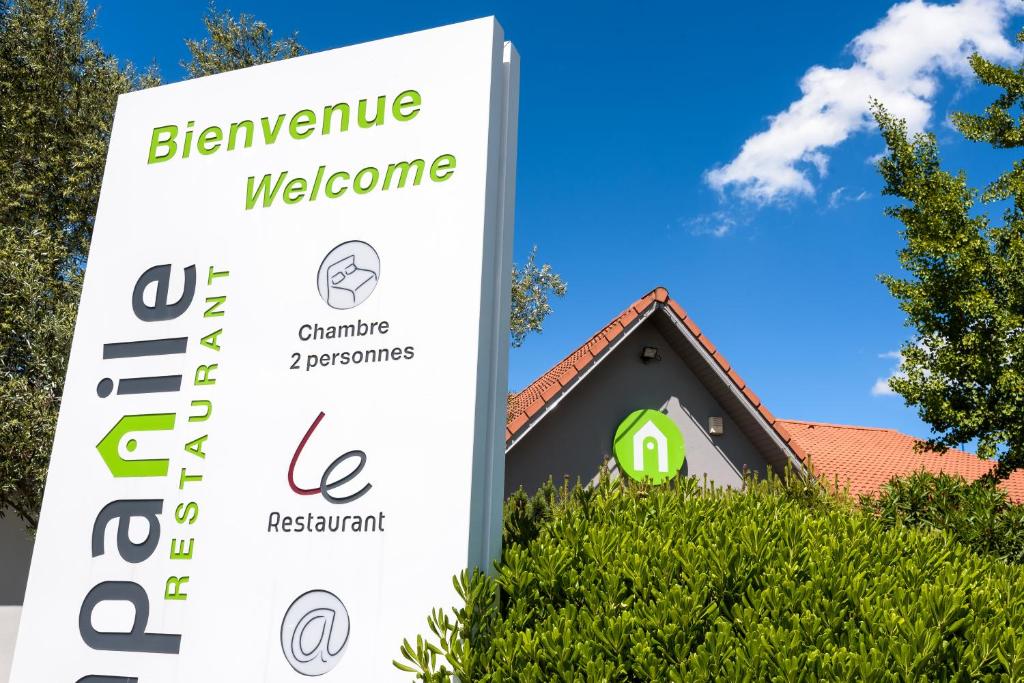 a sign in front of a house with a welcome sign at Campanile Toulouse Sesquieres in Toulouse