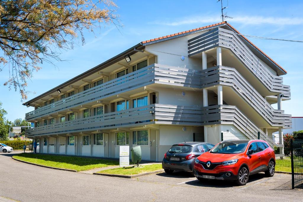 two cars parked in front of a building at Campanile Toulouse Sesquieres in Toulouse