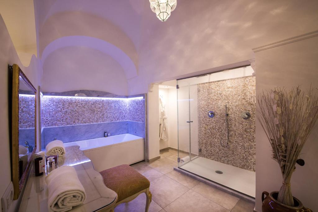 a bathroom with a shower and a tub and a sink at Hotel Villa Gabrisa in Positano