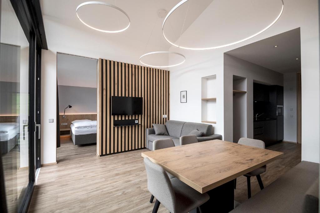 a living room with a table and a couch at Residence Hotel Fever in Ortisei