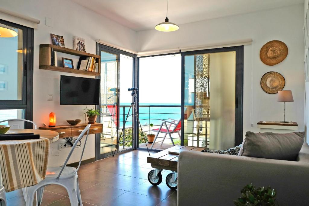 a living room with a view of the ocean at El Morche Beach in Torrox Costa