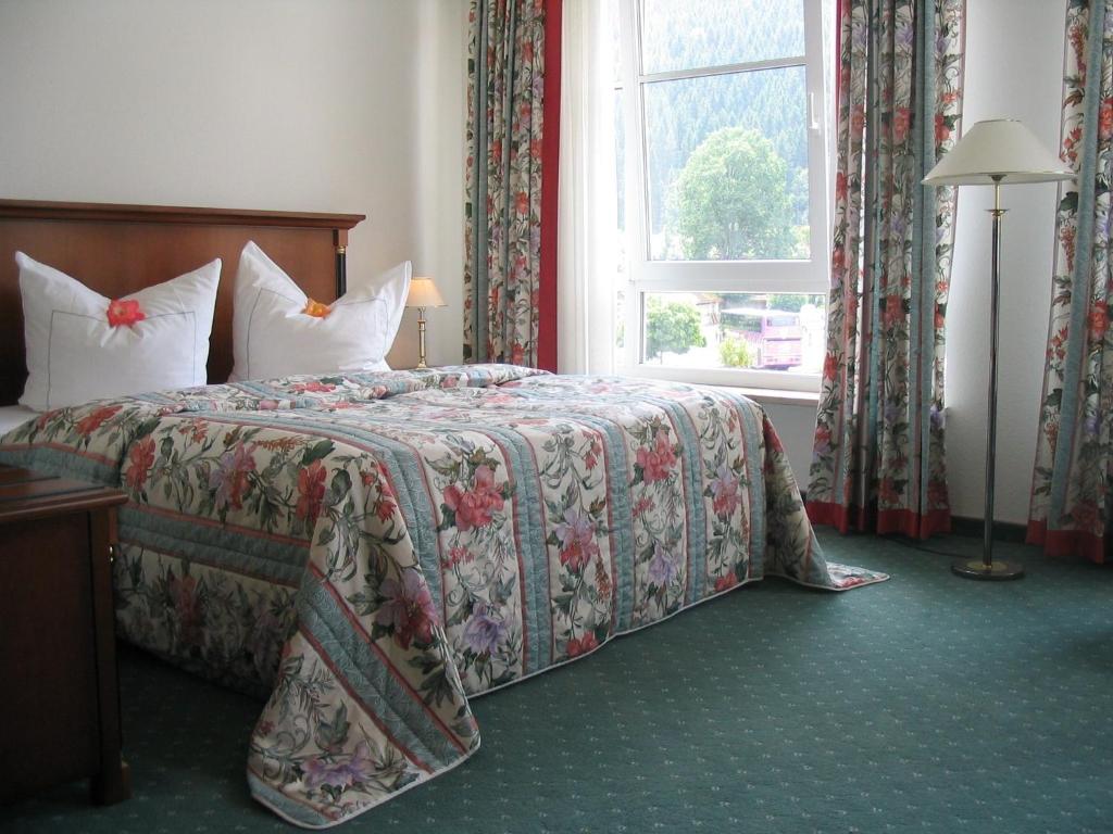 1 dormitorio con cama y ventana en Hotel Garni Aich en St. Blasien