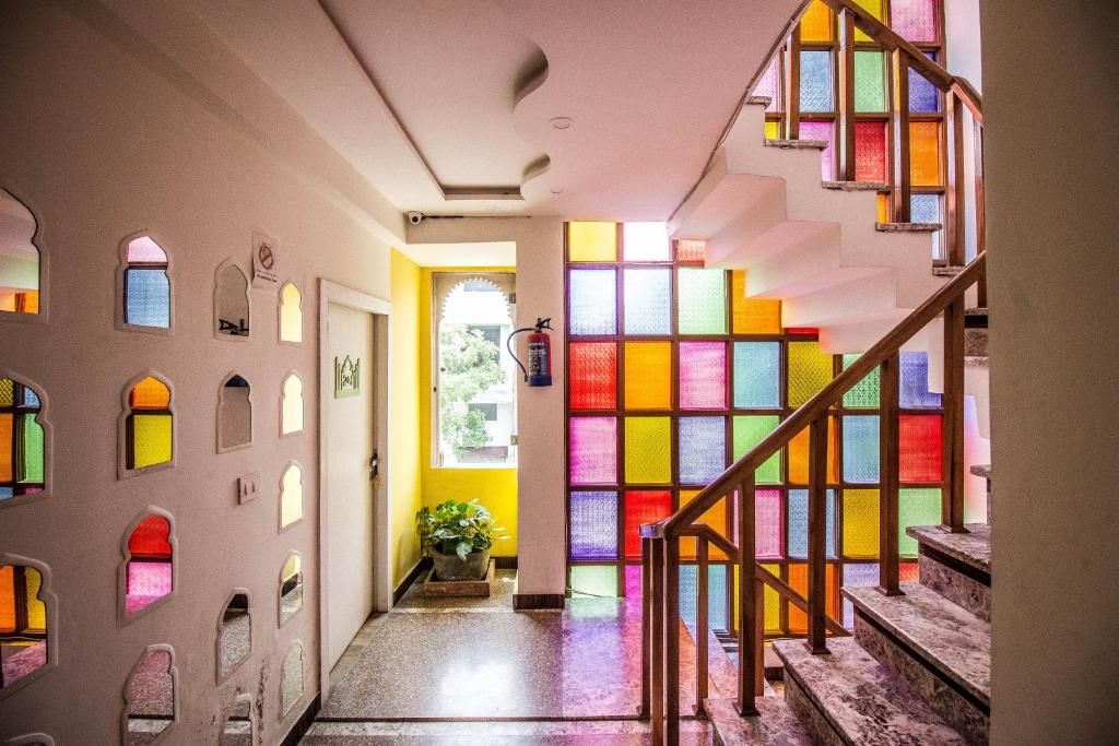 a staircase with colorful stained glass windows in a house at Moustache Agra in Agra