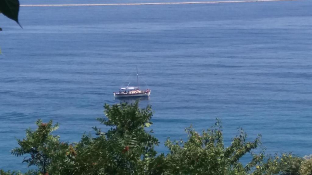 a boat in the middle of a large body of water at Country Art Studio Alkyoni in Kokkino Nero