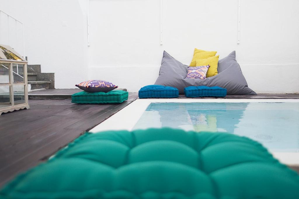 a swimming pool with pillows on the floor next to at Art 4 You Cascais Suites in Cascais