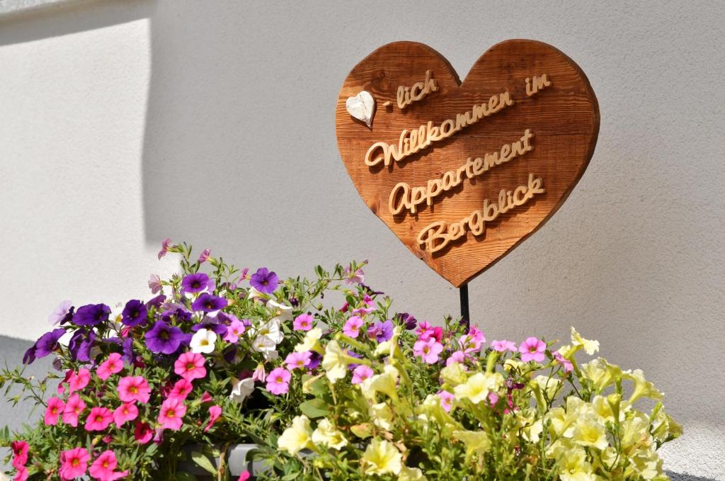 a wooden heart sign in a bunch of flowers at Appartement Bergblick in Neustift im Stubaital