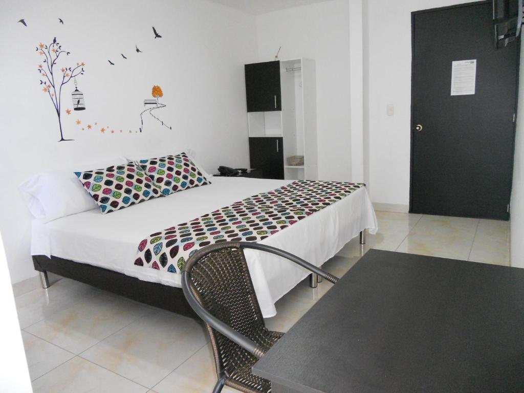 Postel nebo postele na pokoji v ubytování Hotel Cosmos Sincelejo