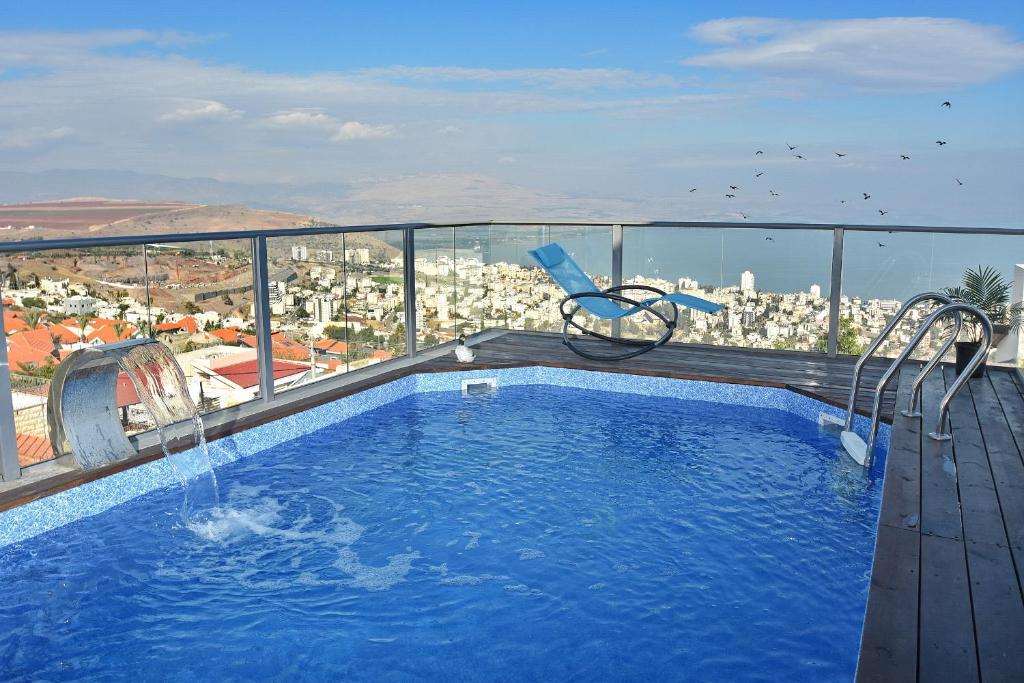 a swimming pool with a view of a city at Luxury Suite with Jaccuzzi & Heated Pool in Tiberias