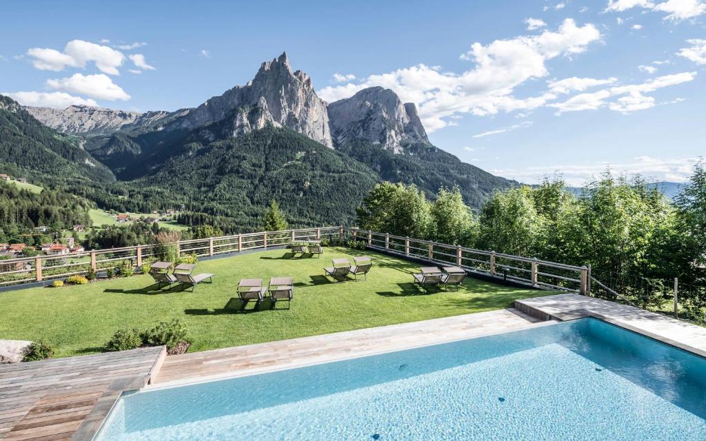 a swimming pool with a view of mountains at Sonus Alpis - Adults Only in Castelrotto