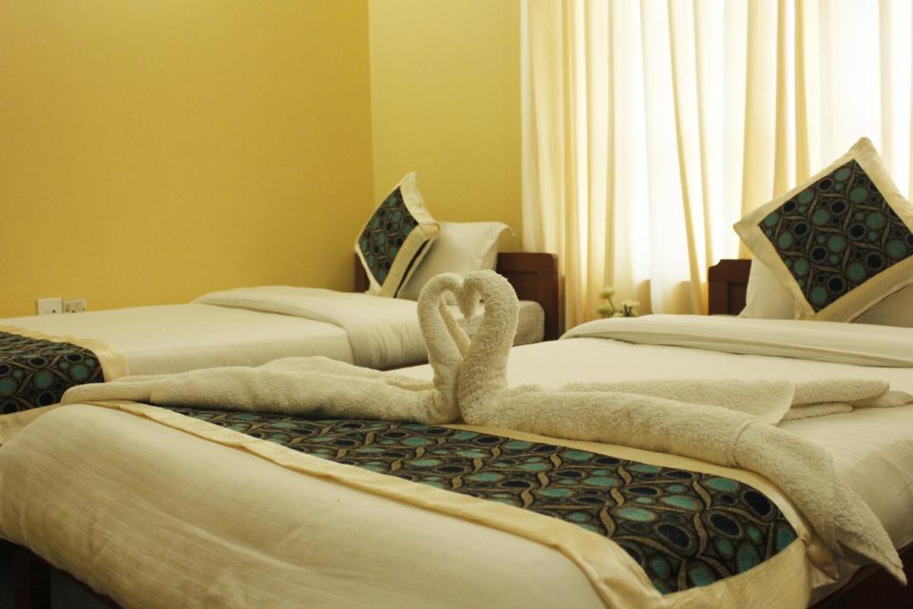 Postel nebo postele na pokoji v ubytování Hotel Nana Pokhara