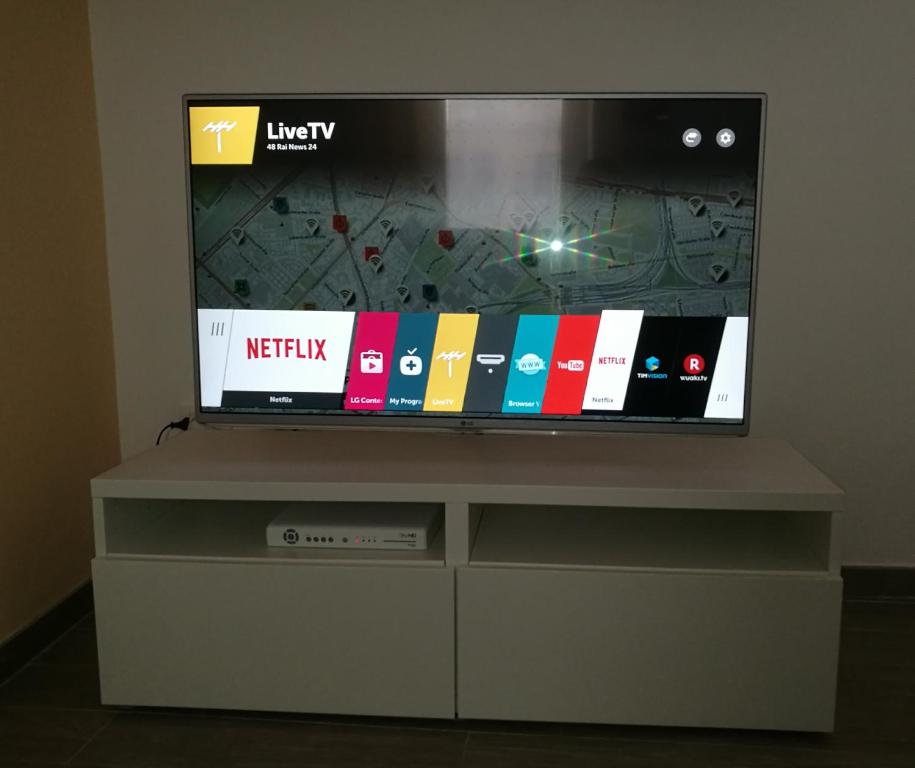 Televízia a/alebo spoločenská miestnosť v ubytovaní Talia Ortigia Apartment