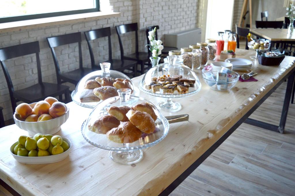 a table with plates of pastries and fruit on it at Agriturismo Statale 17 in Poggio Picenze