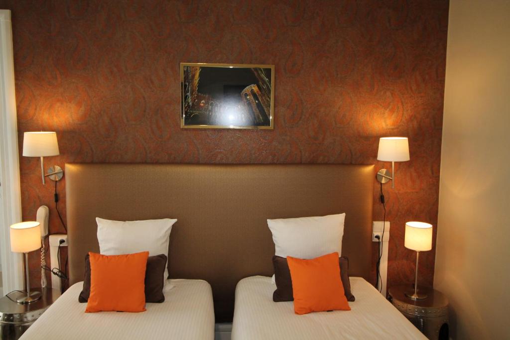 Cama o camas de una habitación en Régina Boutique Hotel
