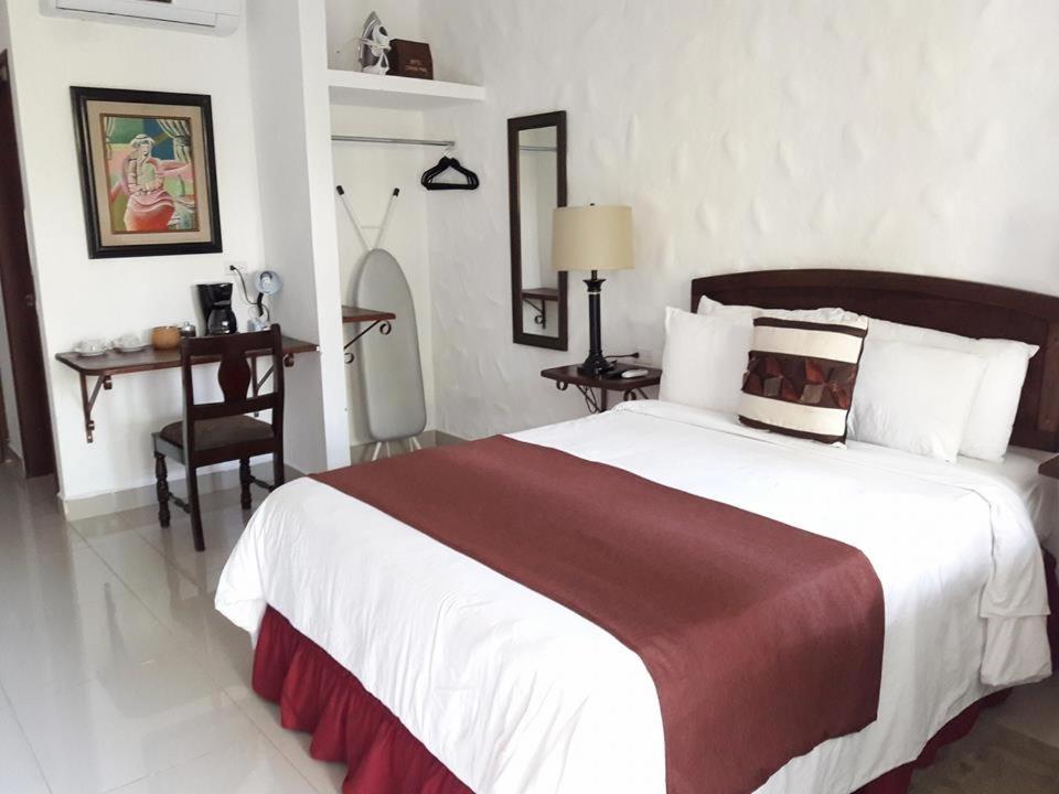 Postel nebo postele na pokoji v ubytování Hotel Ciudad Blanca