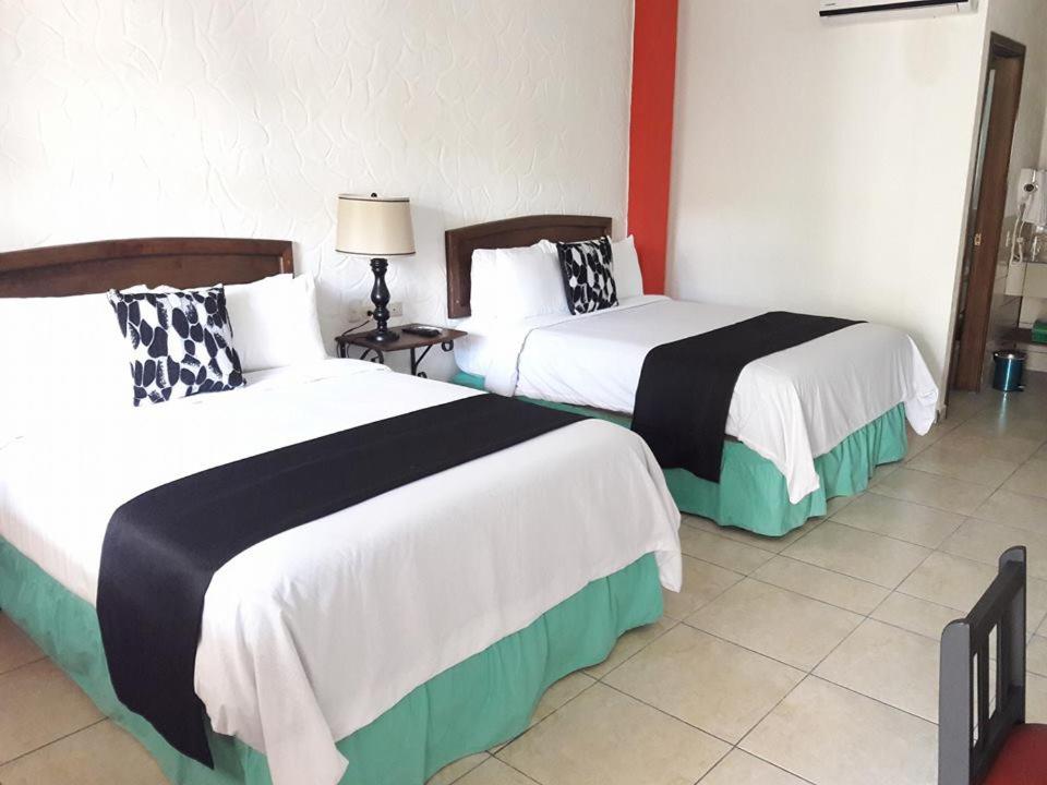 Postel nebo postele na pokoji v ubytování Hotel Ciudad Blanca