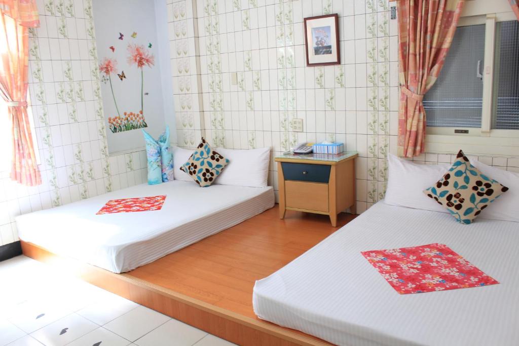 Postel nebo postele na pokoji v ubytování Hsin Hsin Hotel