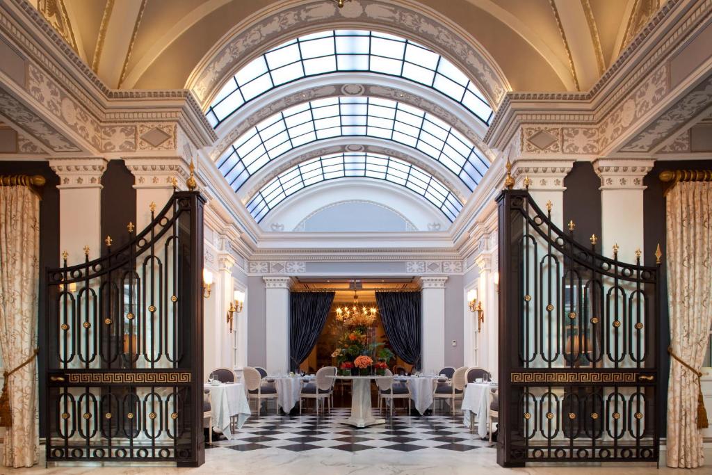 a room with a table and chairs and a large window at The Jefferson Hotel in Washington, D.C.