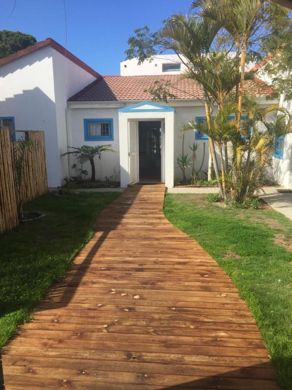 a walkway leading to a house at The Green Palm Cottage in Plettenberg Bay